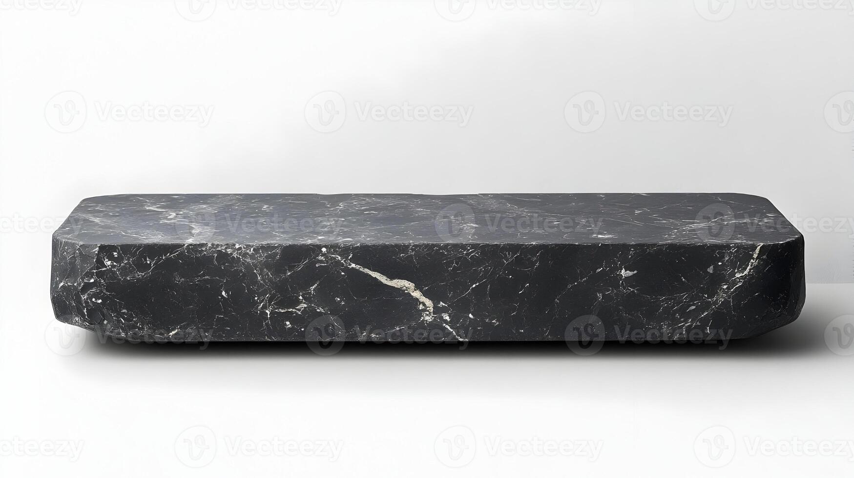 A black marble coffee table with a white base photo