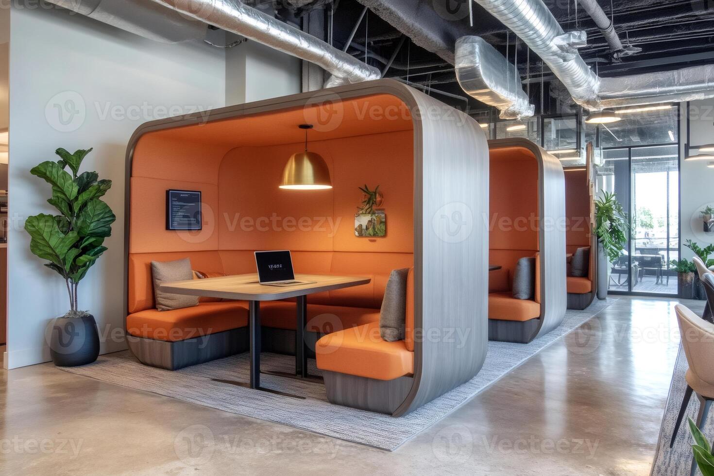 Modern coworking space with comfortable seating pods and exposed ductwork photo