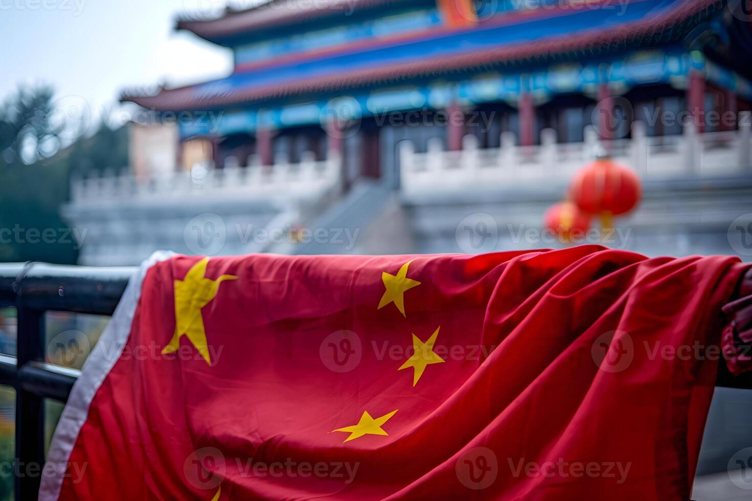Chinese flag hanging on railing with traditional building in background photo
