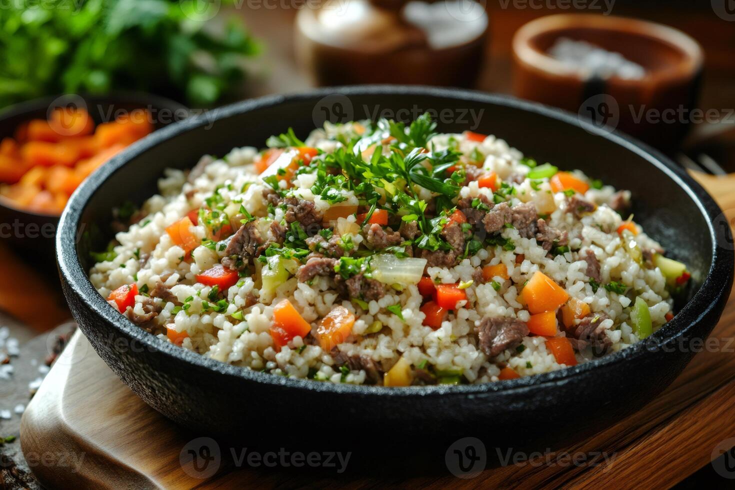 Delicious pilaf with beef and vegetables cooking in cast iron pan photo