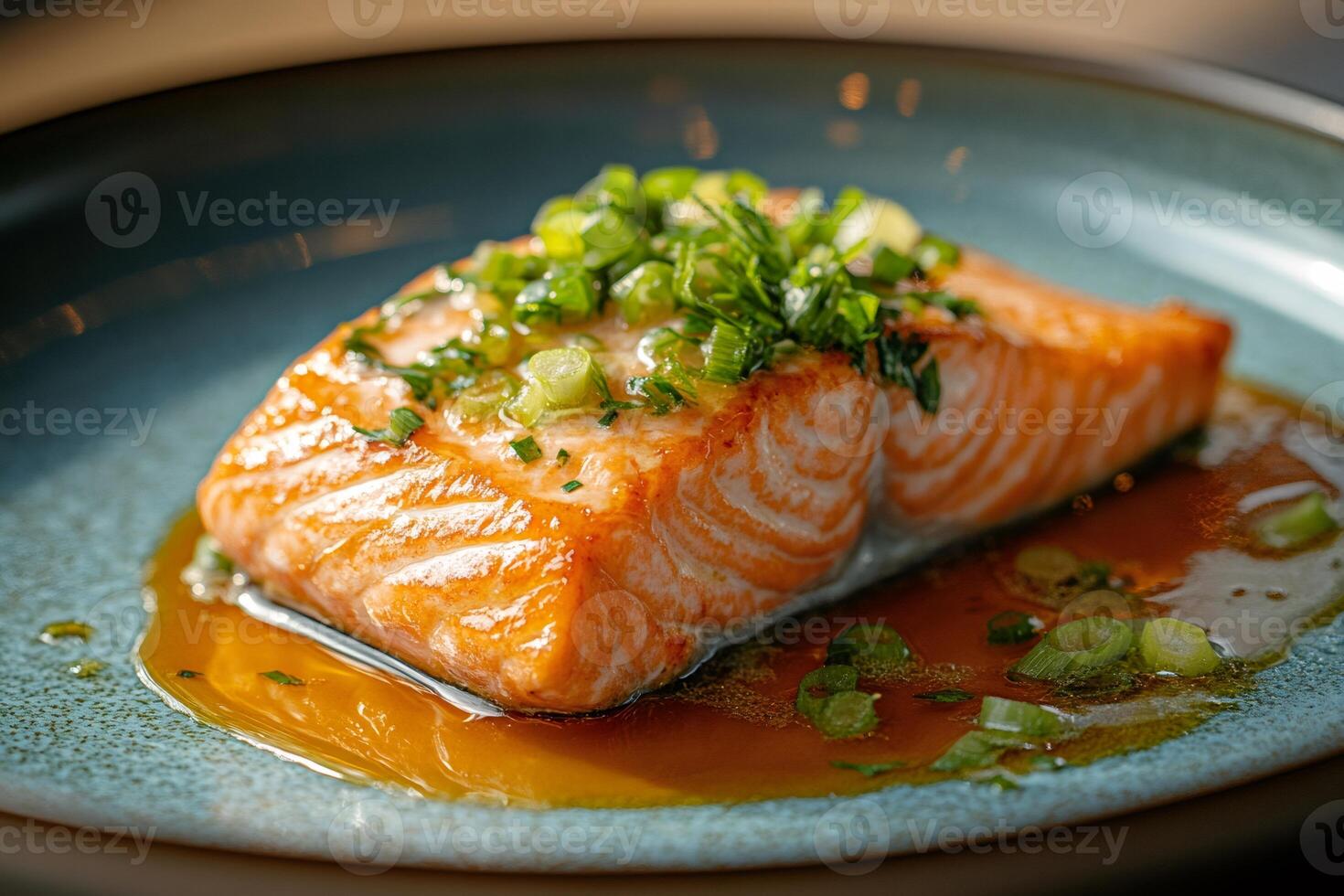 Grilled salmon fillet with chives and soy sauce on elegant plate photo