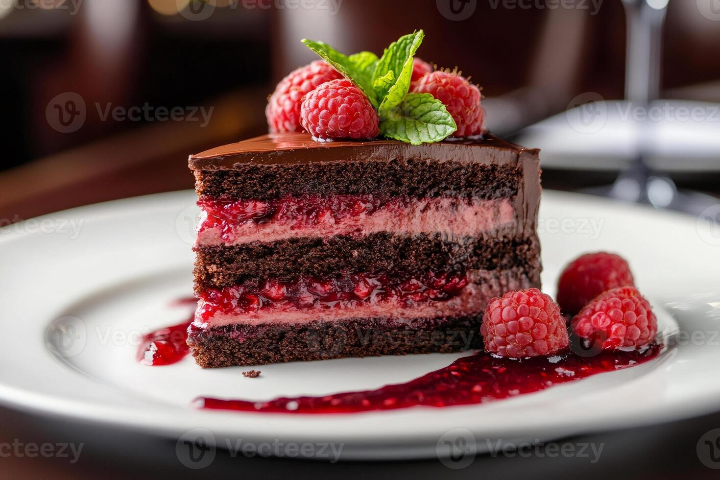 Delicious chocolate cake with raspberry sauce and fresh raspberries topping photo