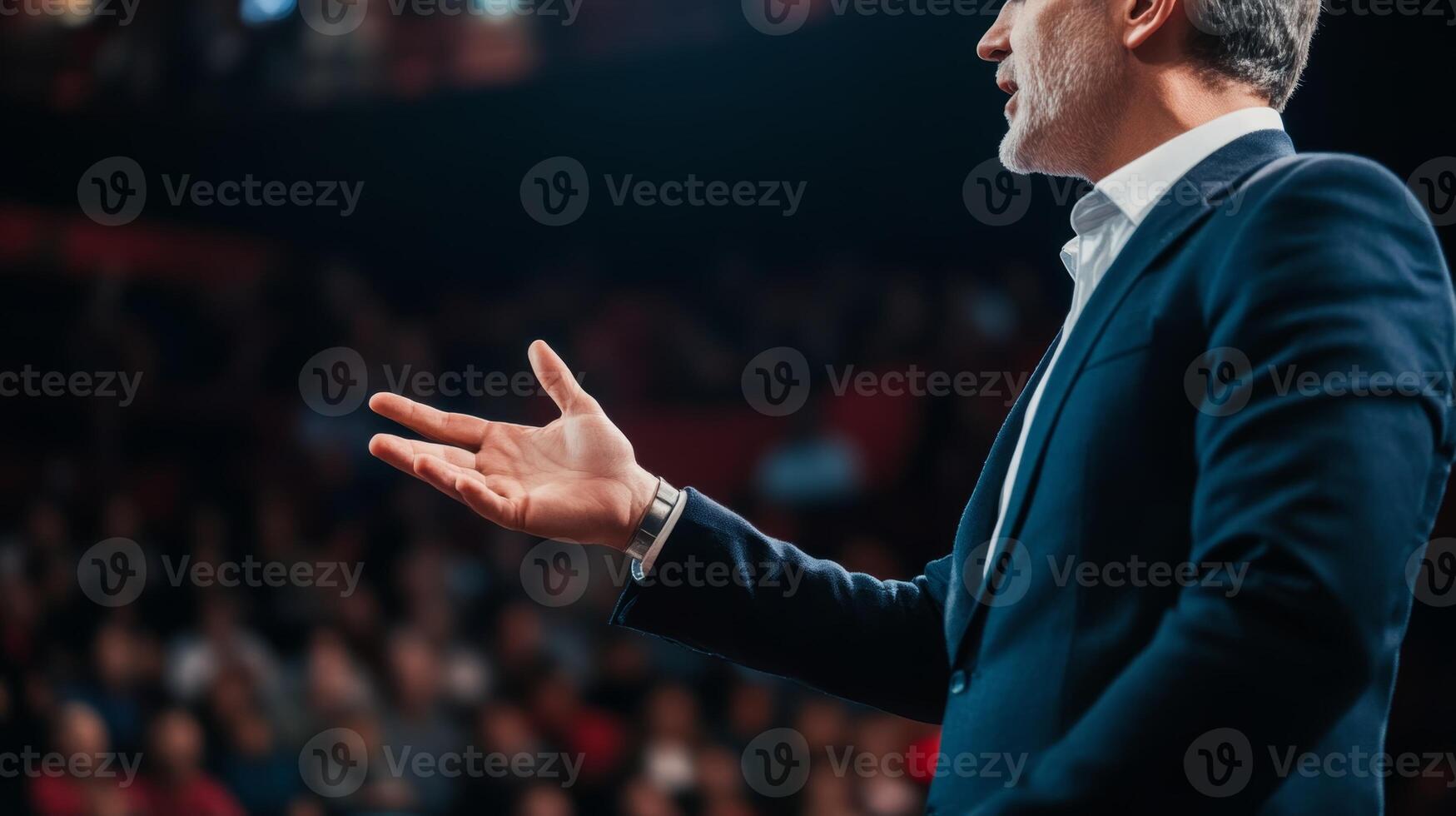 Engaging speaker addressing a captivated audience in a large auditorium during a motivational event in the evening photo