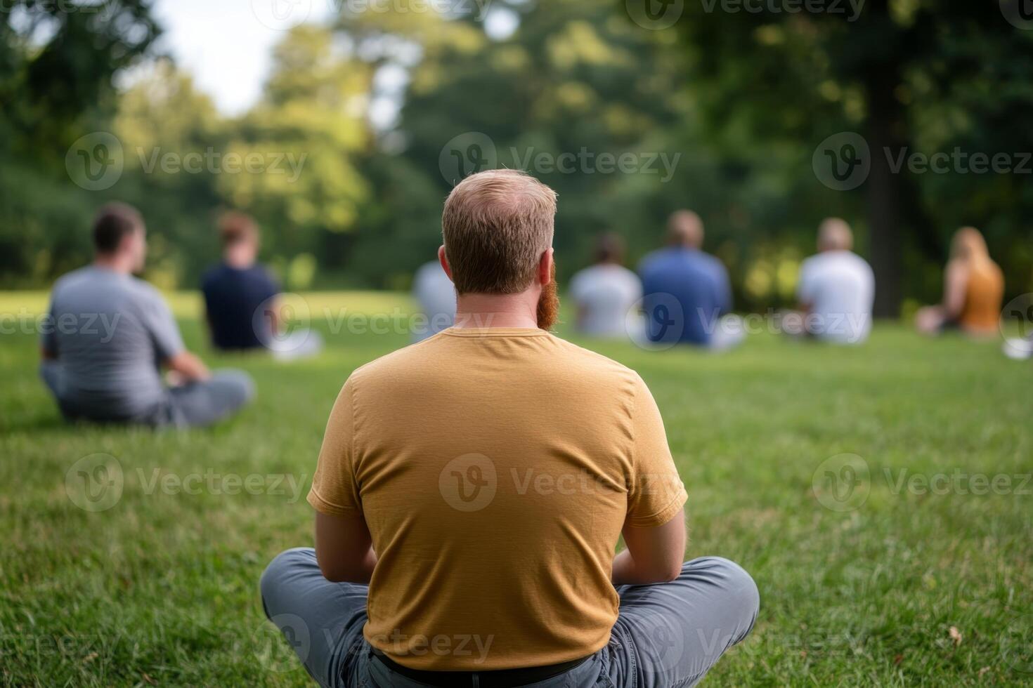 Group meditation session in a serene park setting during a sunny day photo