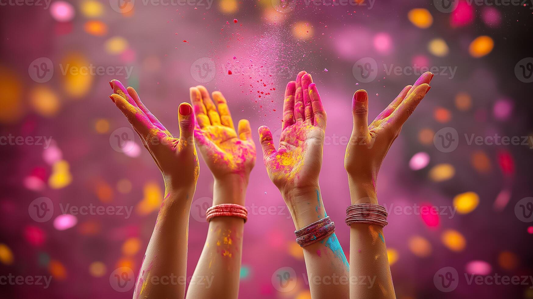 hands with colored powder on them and confetti photo
