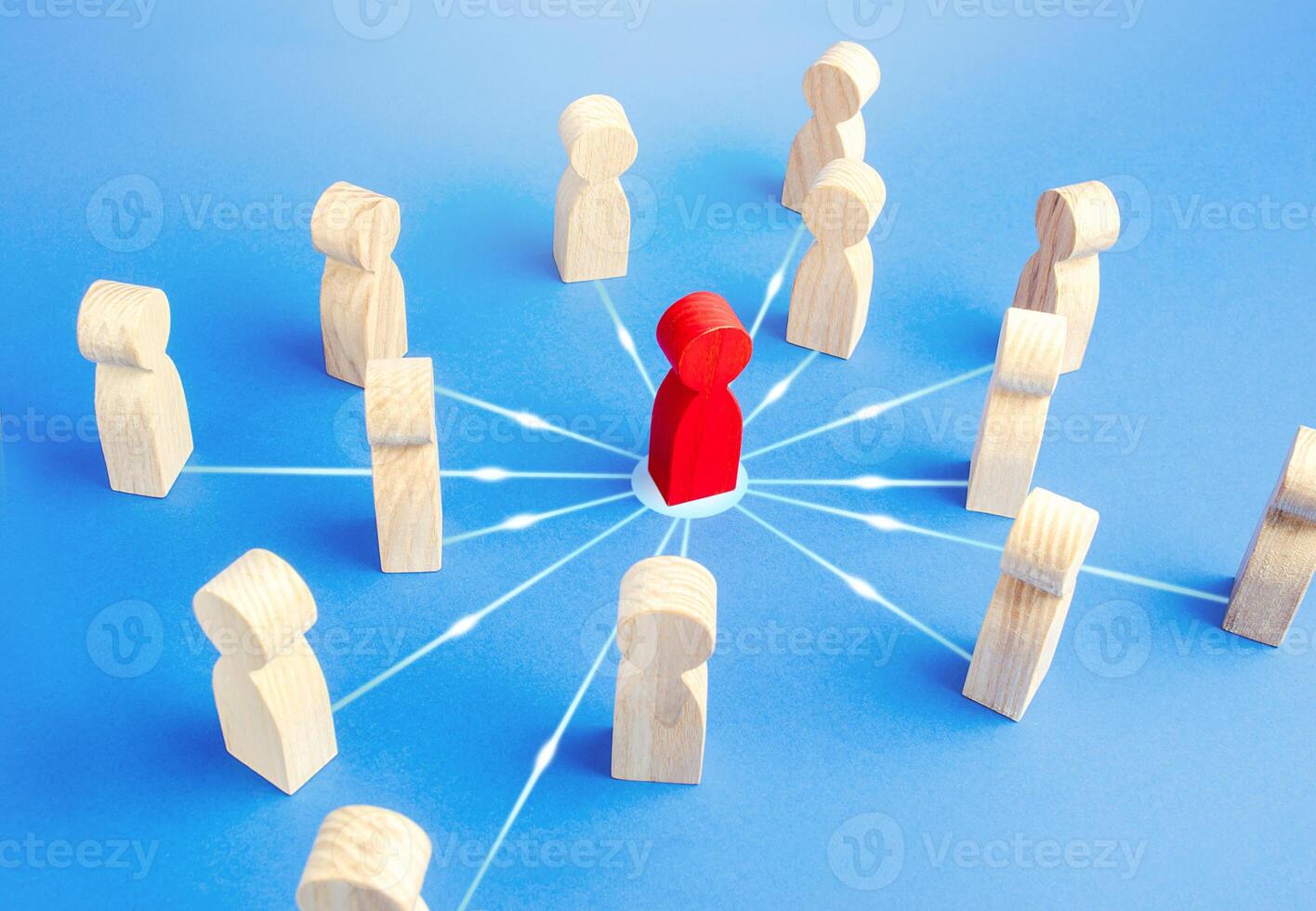 Red person attracts surrounding people. Leadership skills. Followers of leader and his ideas. Cooperation, collaboration to achieve goals. Influence, power. Bringing people together to solve a problem photo