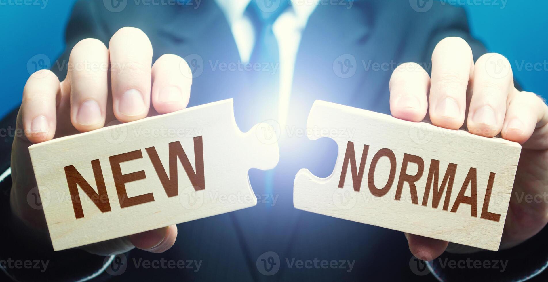 Man collects word New Normal from puzzles. Adaptation of business to post-crisis working conditions, implementation of new rules, search for online sales platforms for products. Opportunities photo