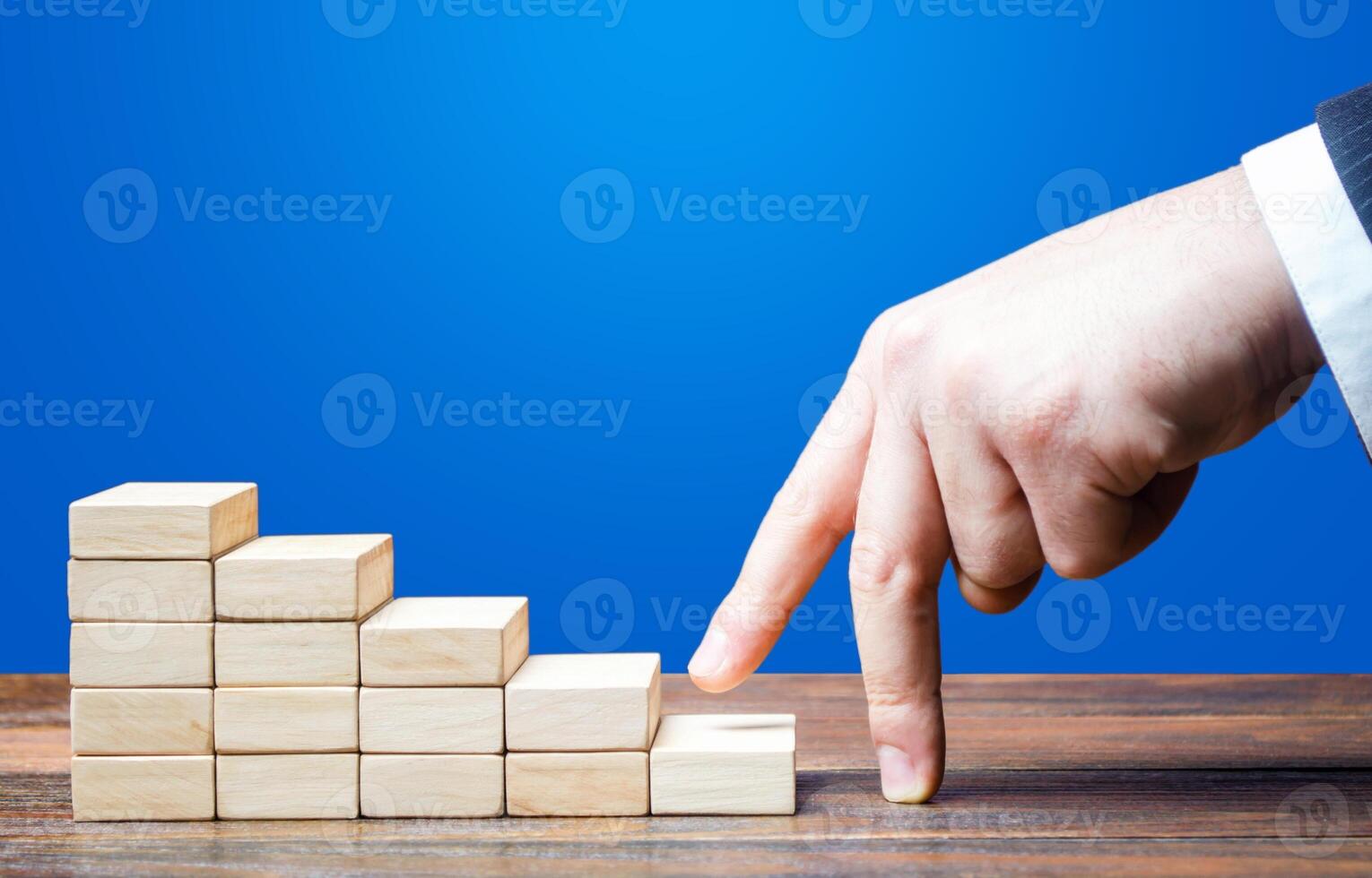 Businessman hand climbs career ladder of success. Going on a new level. Progress and professional growth. Success, Self improvement skills and abilities. Appointment of an employee to a new position. photo