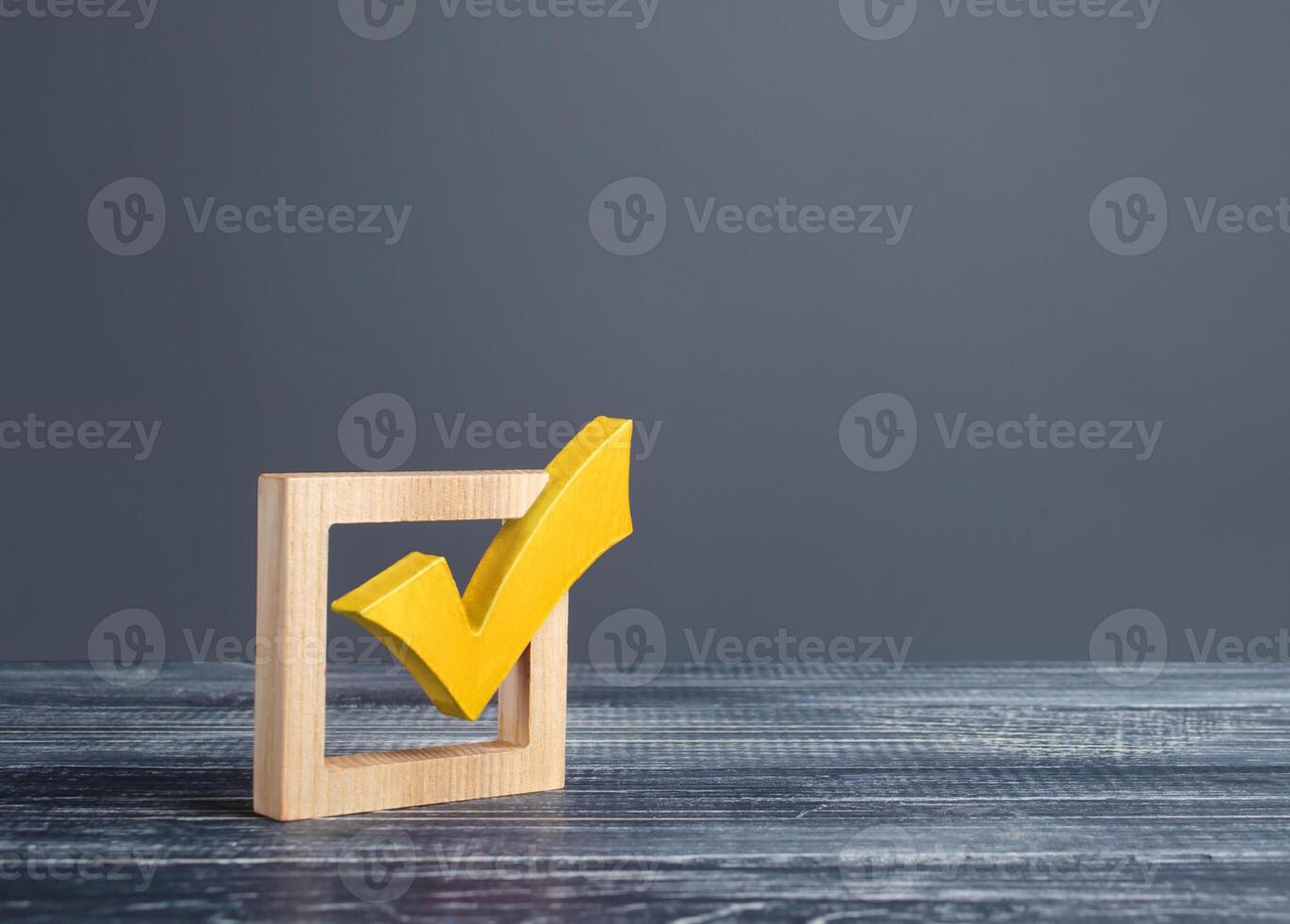 Yellow voting tick in a checkbox. Democratic institutions, vote on democratic elections, referendum. Opinion Poll. Make right choice. Confirmation, passing the test. Verification. Law implementation photo