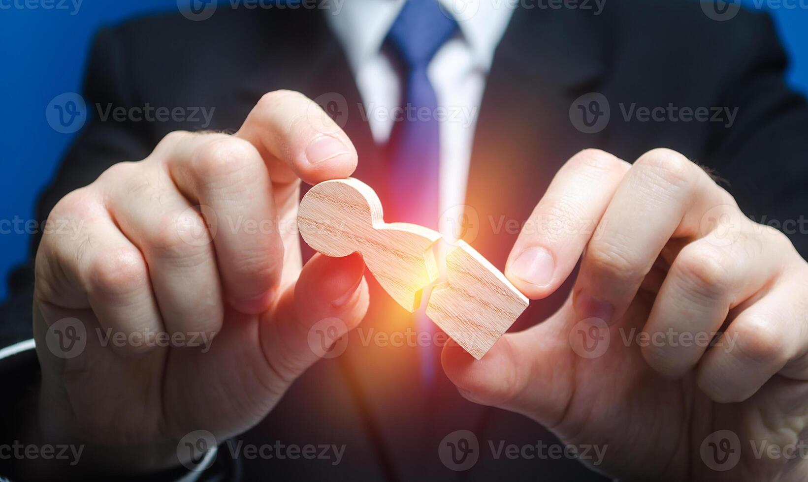 Man breaks human figure. Enmity and revenge, causing damage to employee. End of career, dismissal from work. Stress physical exhaustion from strong pressure of authorities. Excessive exploitation. photo
