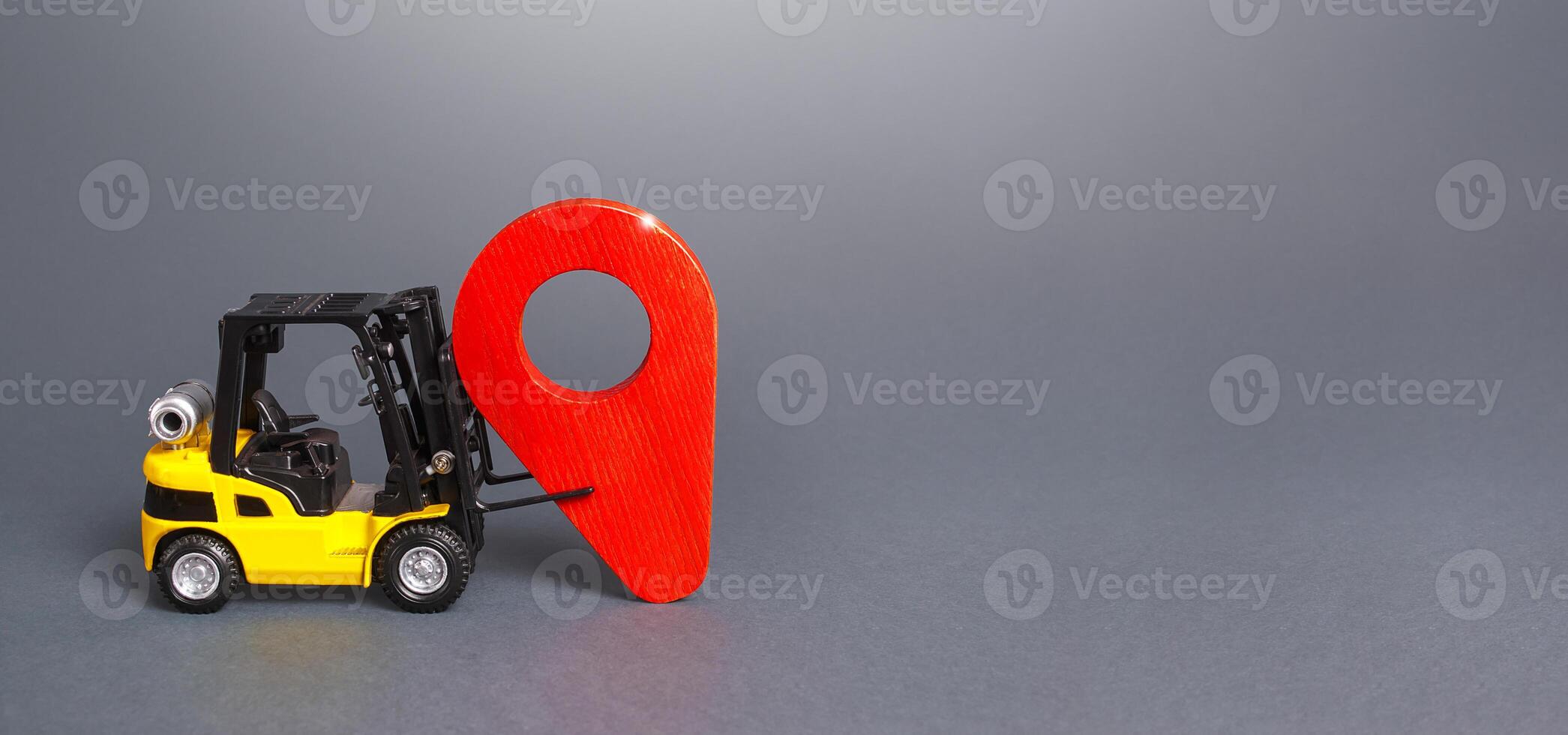 The forklift sets a red pin location indicator. Delivery and distribution of goods products. Logistics, transportation. Trade, cargo freight traffic. Relocation of production. Economic protectionism. photo