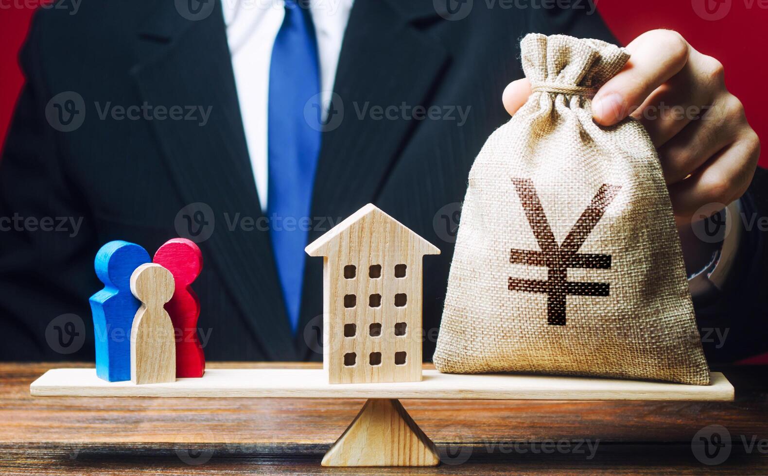 Man puts Yen yuan money bag and house on scales with a family. Mortgage, debt burden. Assistance with housing and financing for young families to stimulate childbirth demographic population growth. photo