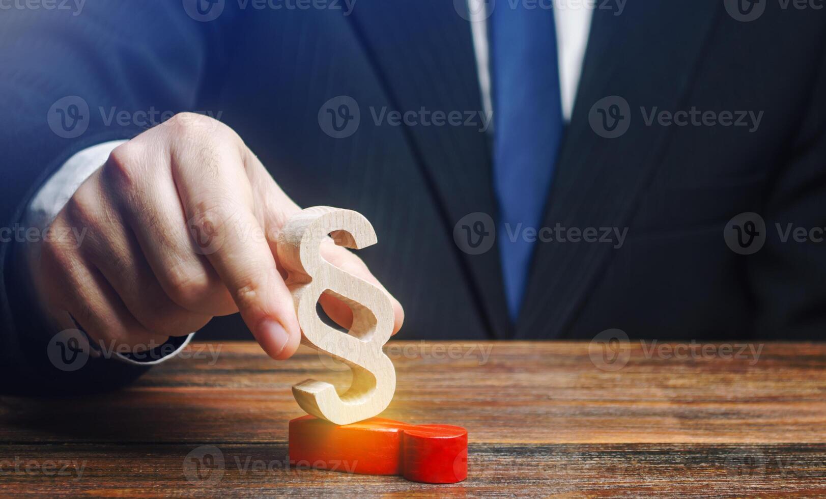 A man deals with his opponent with a paragraph figure. Usurpation of power. Deserved punishment of the criminal. Suppression of dissatisfaction disagreement with new laws. Reduction of protest moods. photo