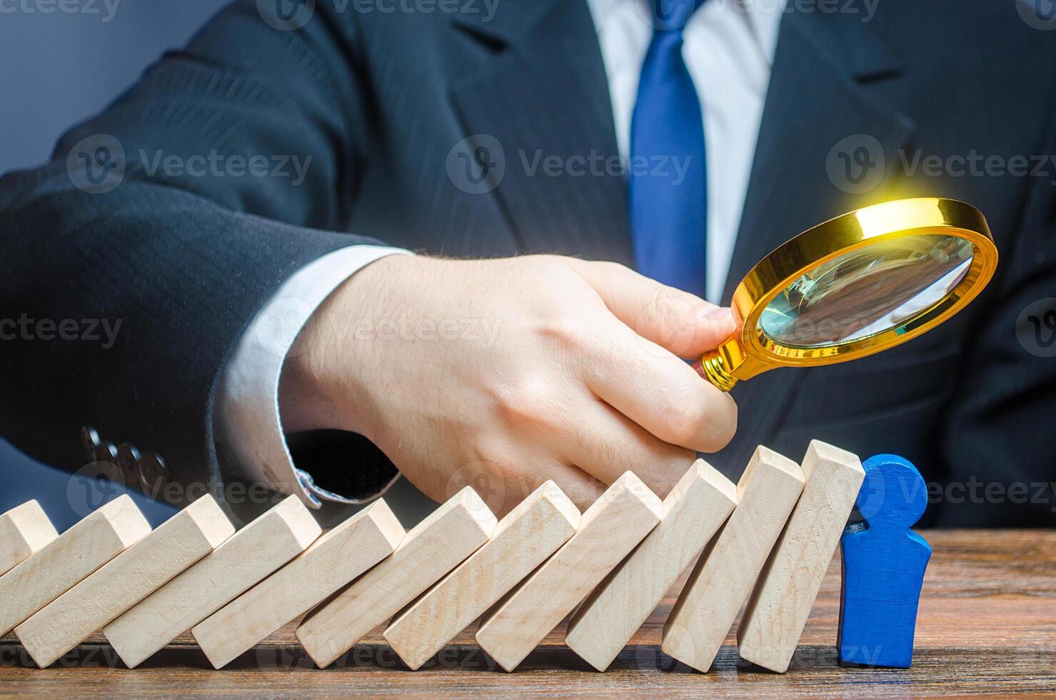 A businessman is studying stress resistance of a blue leader figure after a domino fall. Complete task, brilliant performance of work and responsibilities, pass the test. Reliable employee. photo