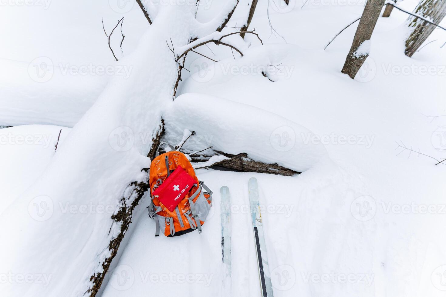 A person is joyfully skiing down the snowcovered slope with a backpack placed on the ground beside them, enjoying the beauty of winter and the thrill of outdoor adventure photo