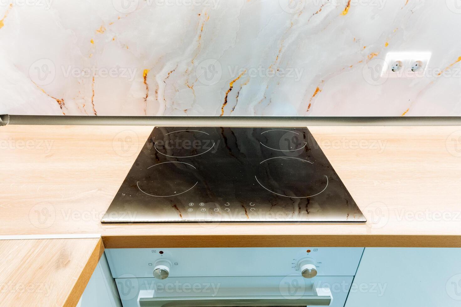 A stove top oven, a versatile kitchen appliance, is placed on a beautifully crafted wooden counter, enhancing both the functionality and aesthetic of the welldesigned kitchen space photo