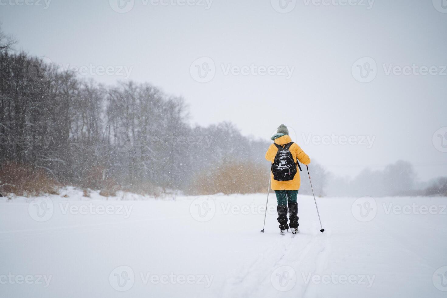 A person is enjoying cross country skiing in the fresh, glistening snow, making the most of the winter season and the opportunity for outdoor recreation in the cold weather photo