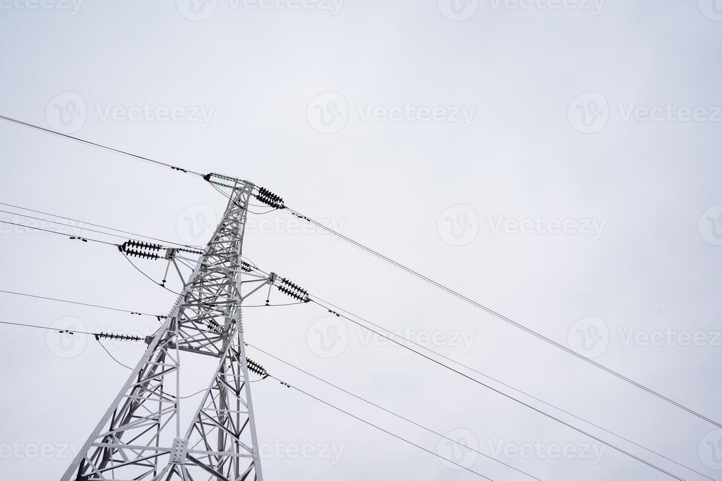 This captivating black and white photograph highlights a prominent power tower, showcasing extensive power lines that stretch gracefully across the sky in an impressive and artistic manner photo