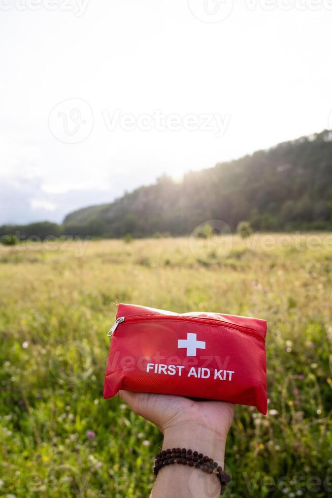 A First Aid Kit Ready for Immediate Use in a Scenic Outdoor Setting Surrounded by Nature and Breathtaking Views photo