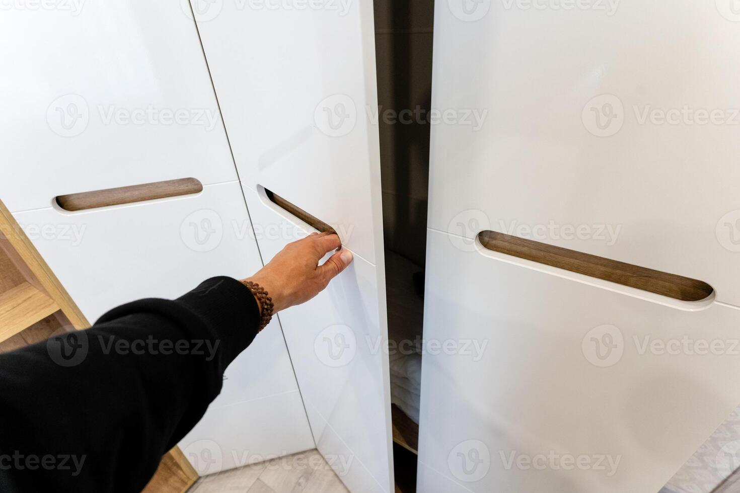 The contemporary closet design showcases a minimalist aesthetic and features stylish and sleek handles photo