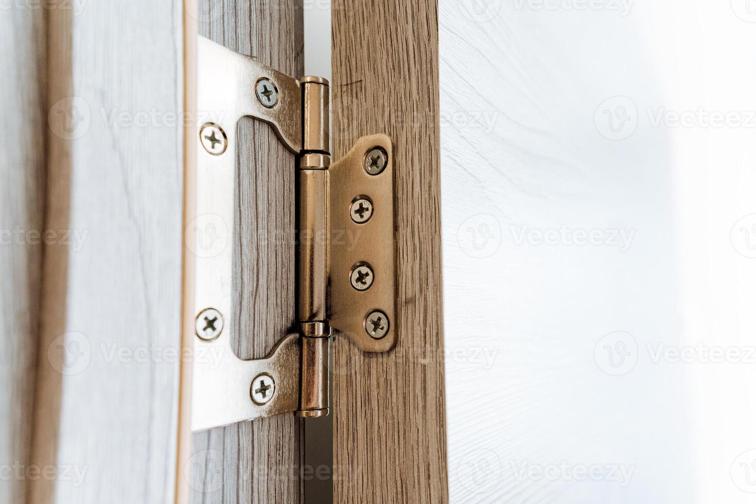 Closeup of a wooden door hinge, a key fixture in household hardware photo