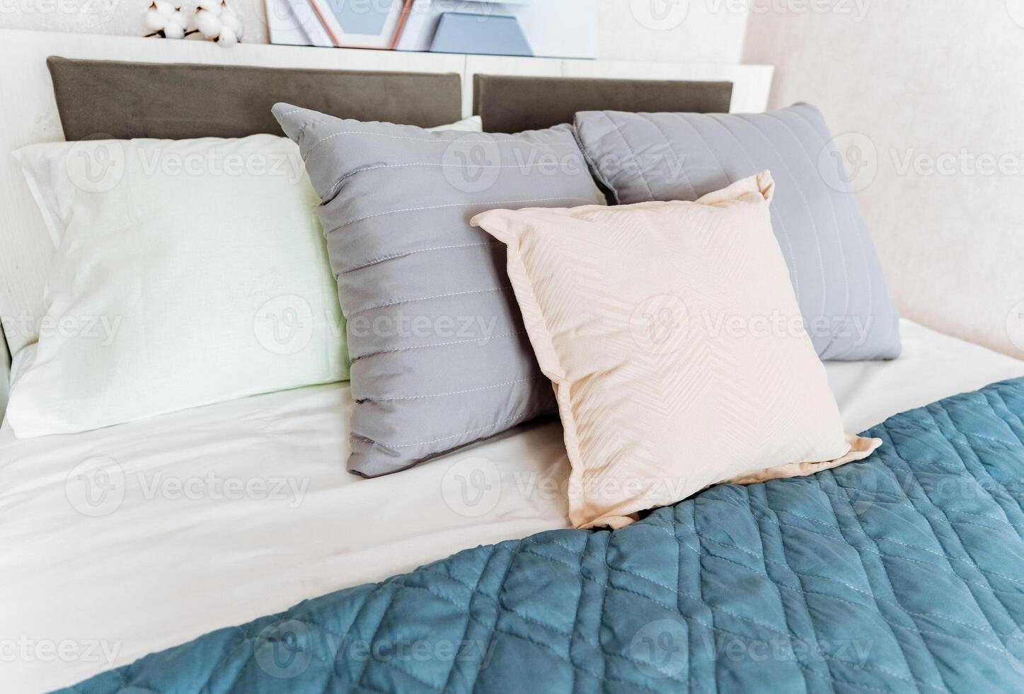 Comfortable hardwood bed frame with pillows and quilt in a rectangular shape photo