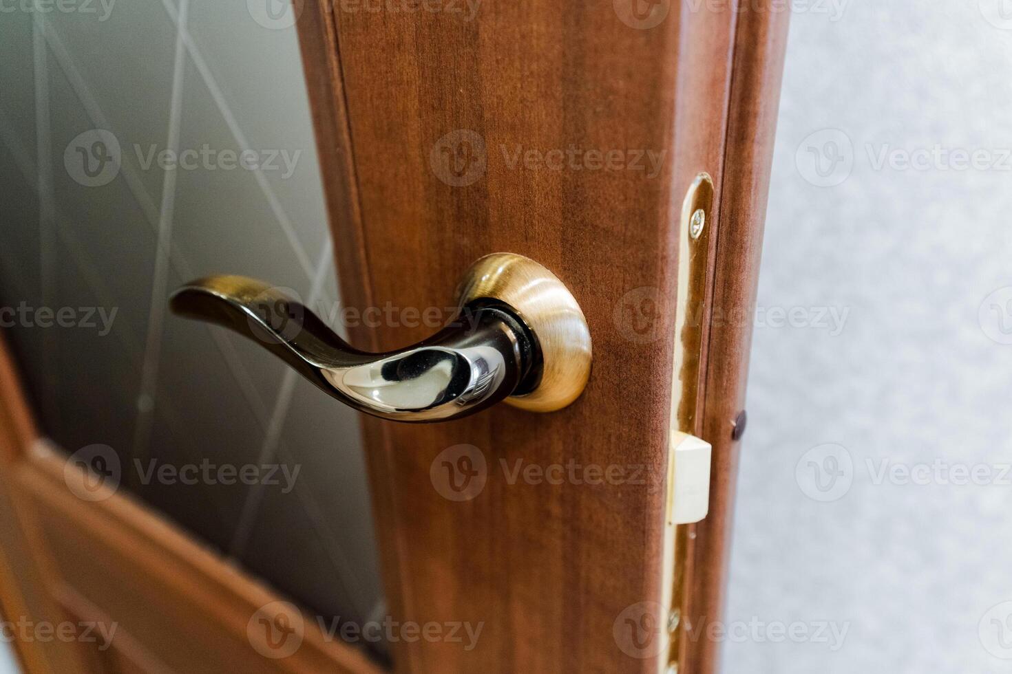 Close up of a varnished hardwood door handle on a wooden door photo