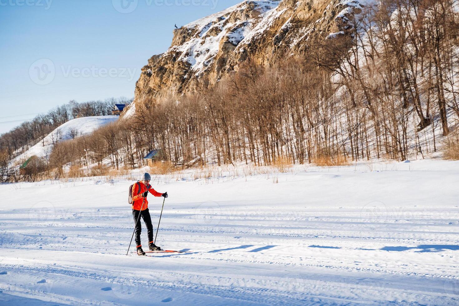 Enjoying cross country skiing on a frozen lake under the sky photo