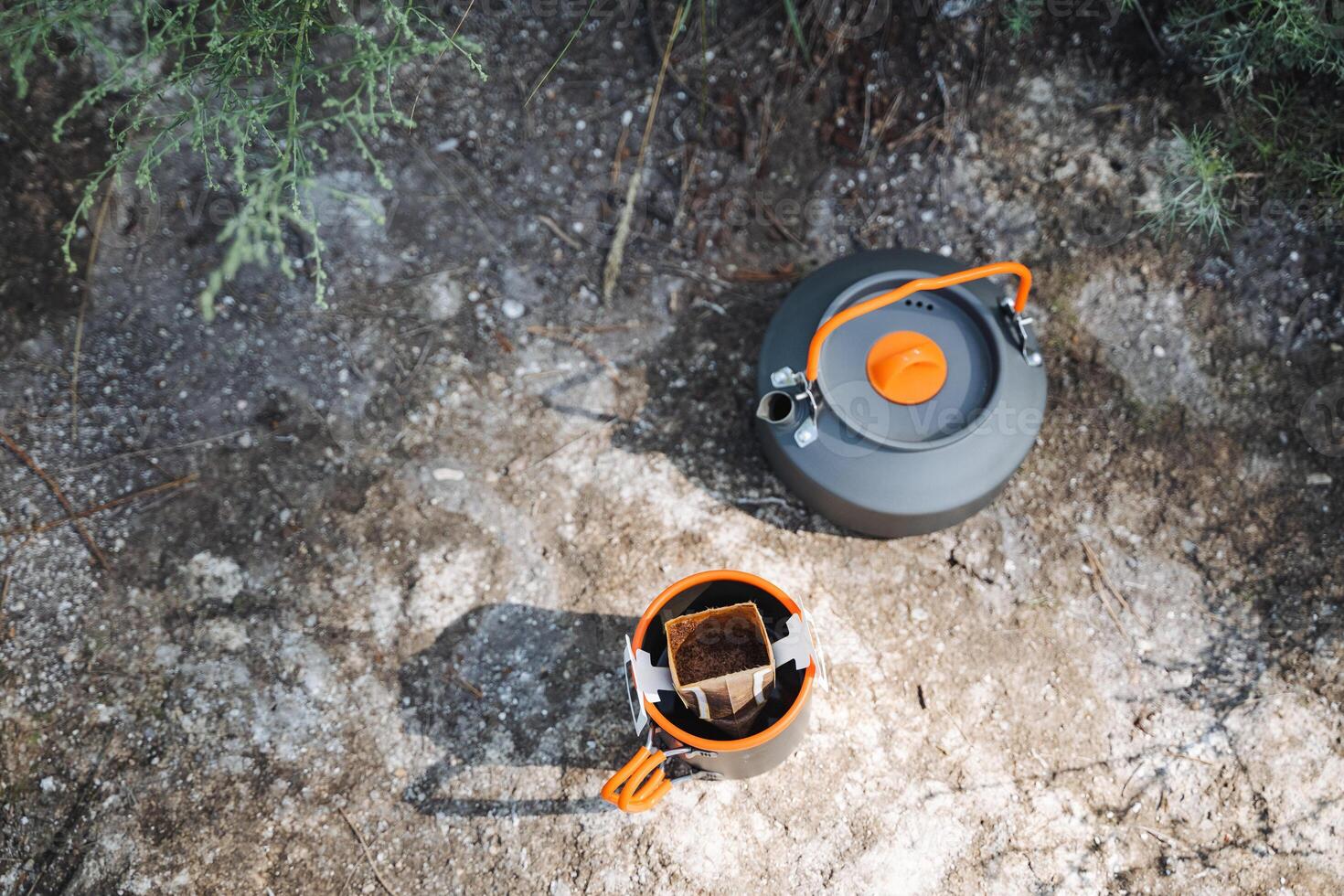 Both a kettle and a coffee cup are on the floor, placed close to each other. This arrangement enhances the cozy atmosphere in the room, making it feel warm and welcoming photo