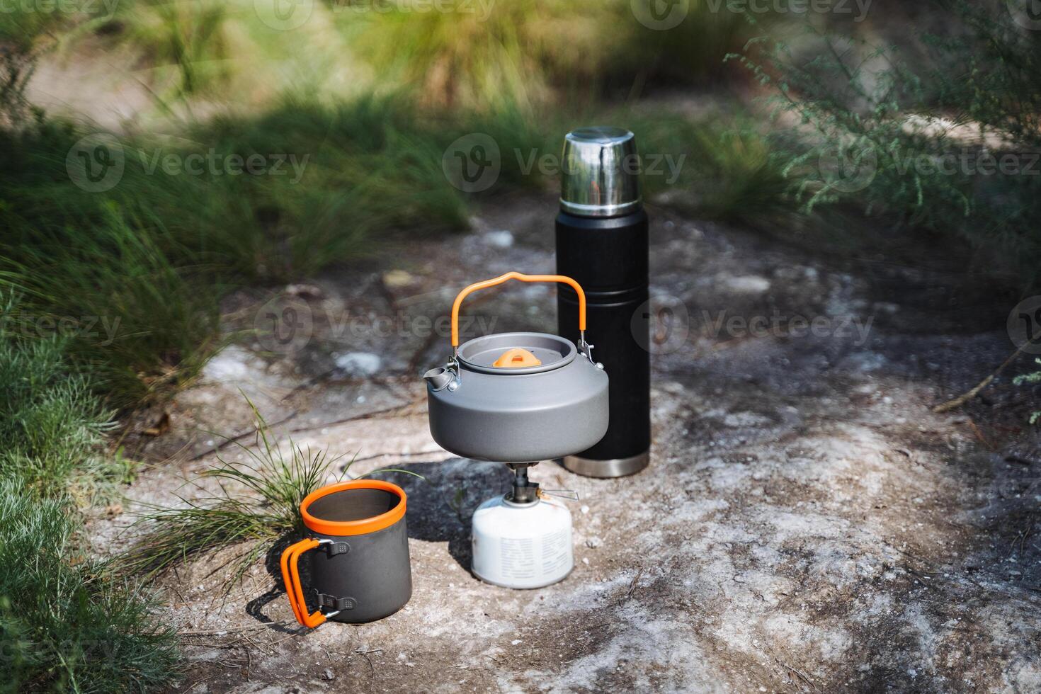 To fully enjoy your adventure in the great outdoors while camping, make sure to bring essential items like a kettle, mug, and thermos for a memorable experience photo