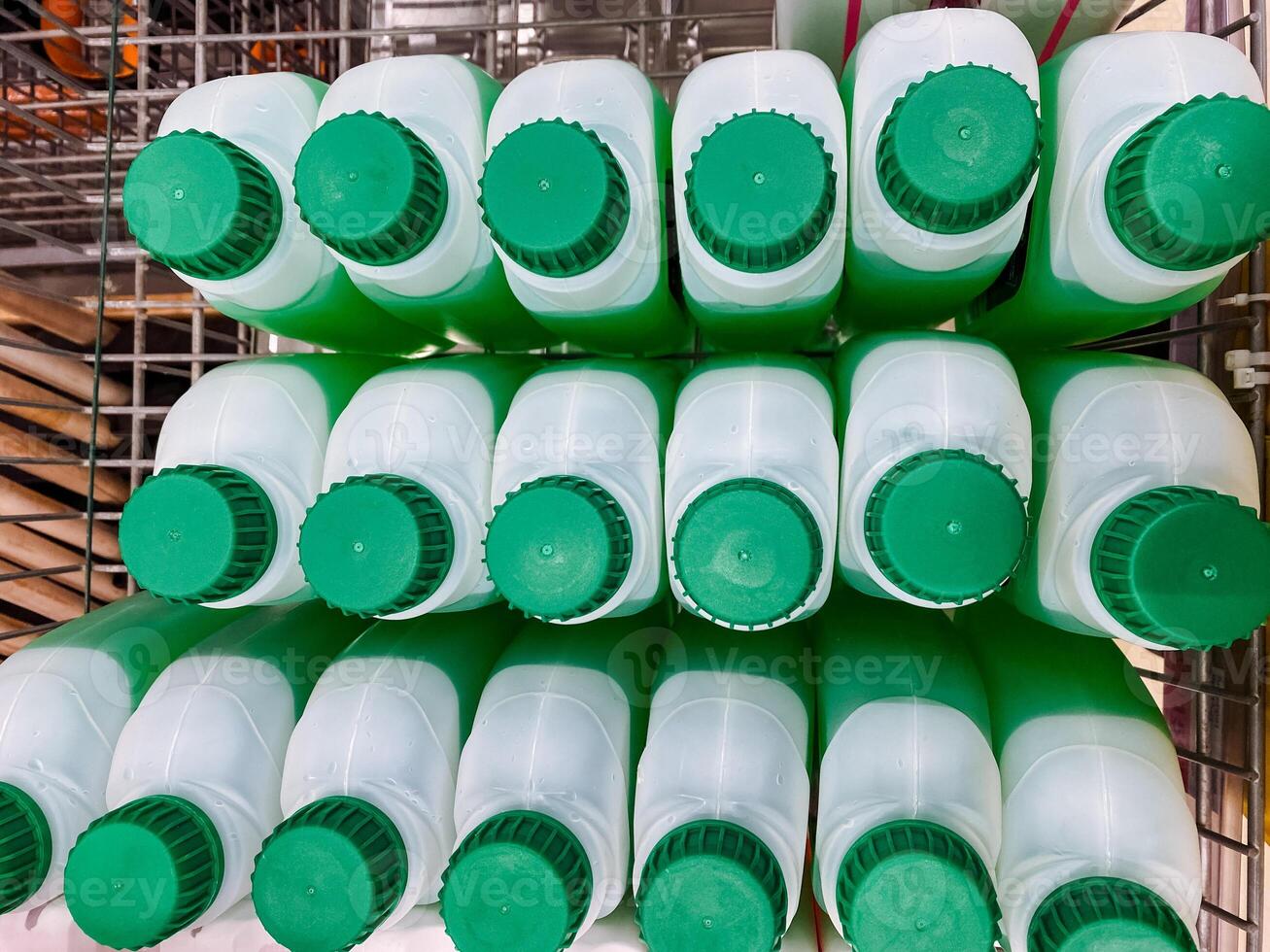 A bunch of green and white bottles stacked on top of each other photo