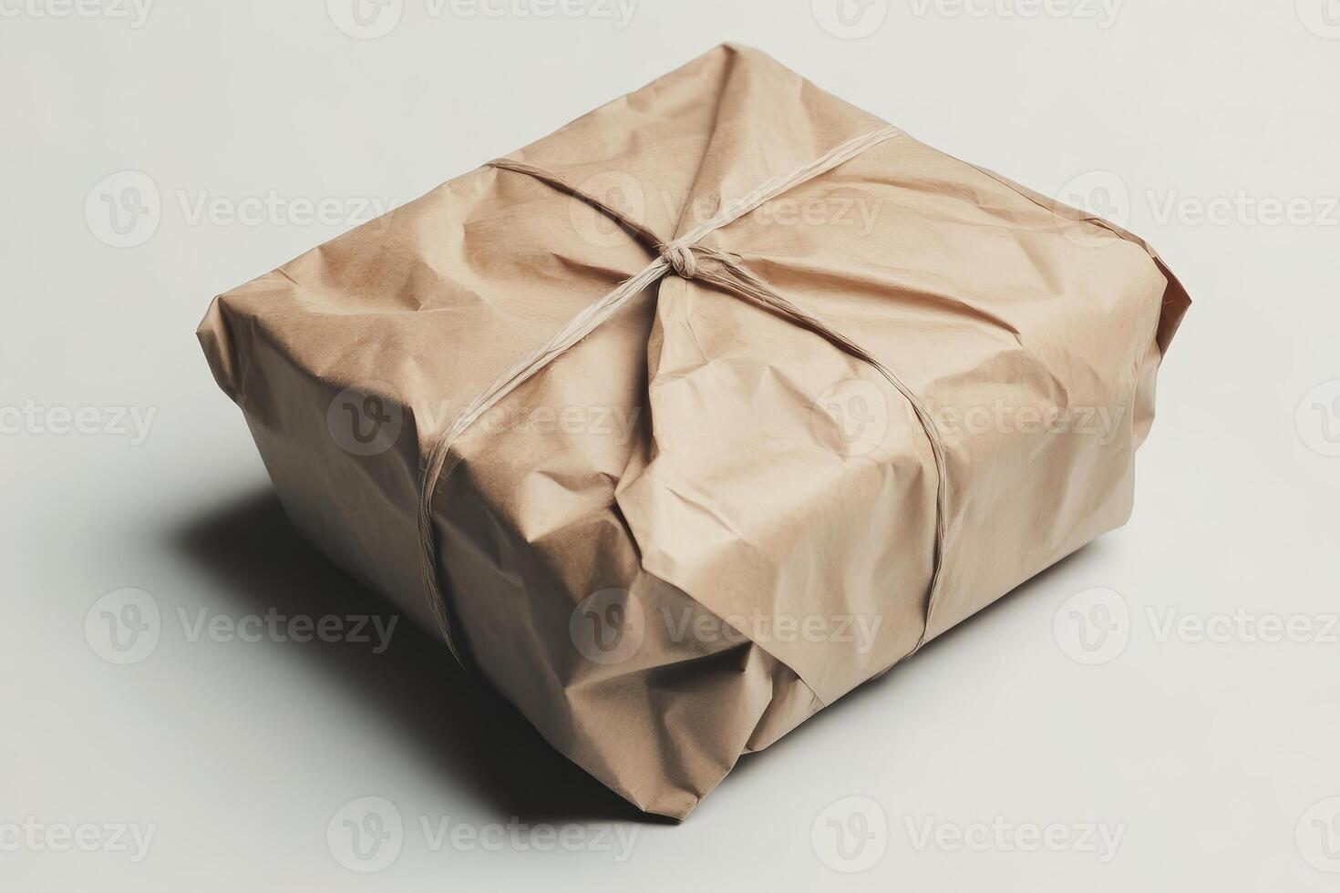 Brown Paper Package Tied with String on Neutral Background photo