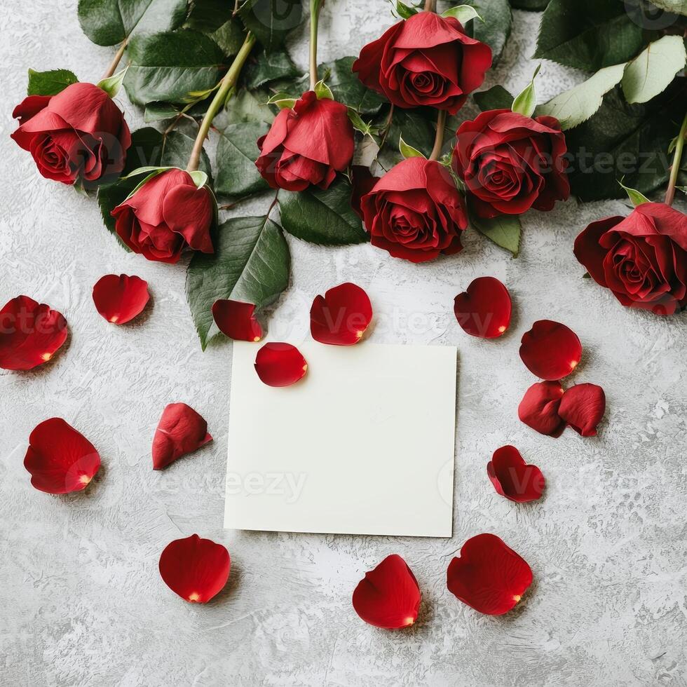 Valentine roses passion concept. Roses with petals surrounding a blank card on a textured surface. photo