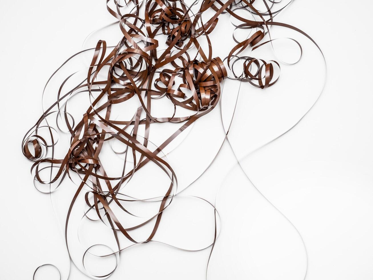 closeup of a piece of magnetic tape tangled on white background photo