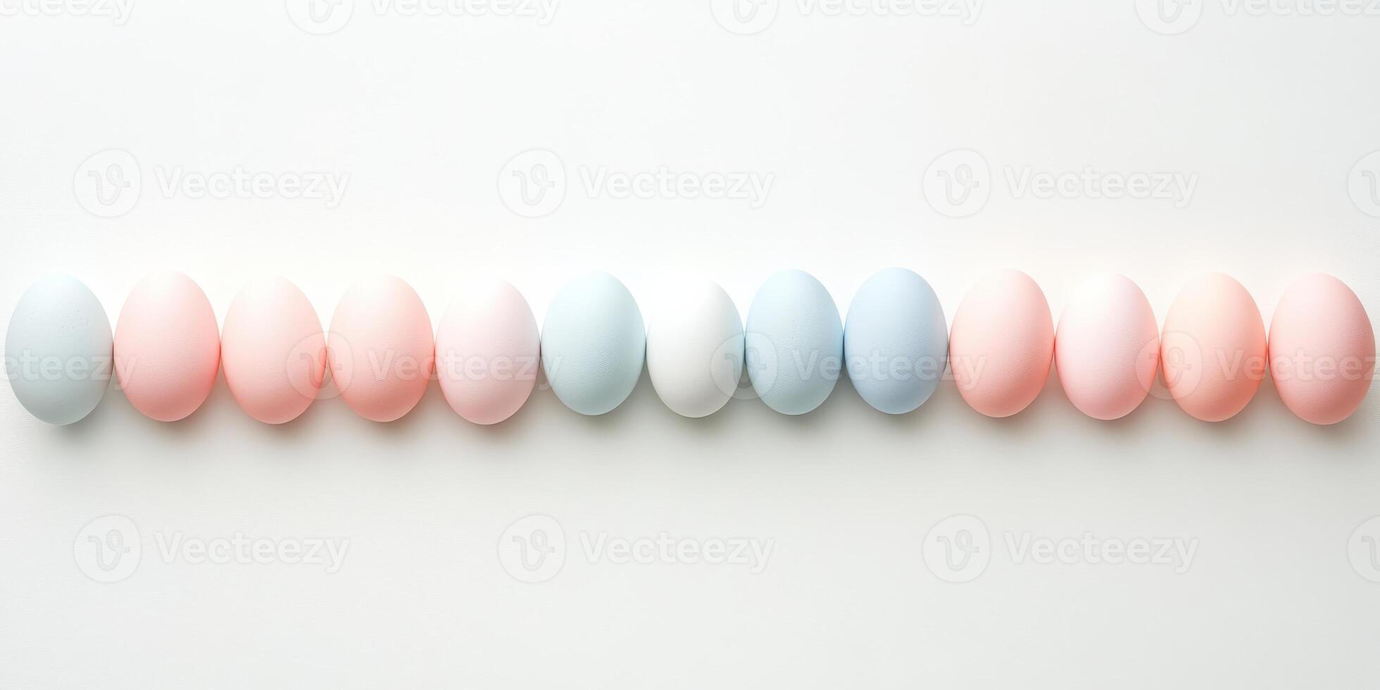Pastel colored eggs aligned in a row against white background, minimalist easter concept photo