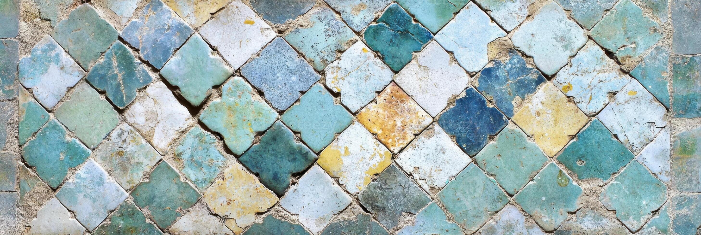 Weathered mosaic tiles with worn color variations in a diamond pattern photo