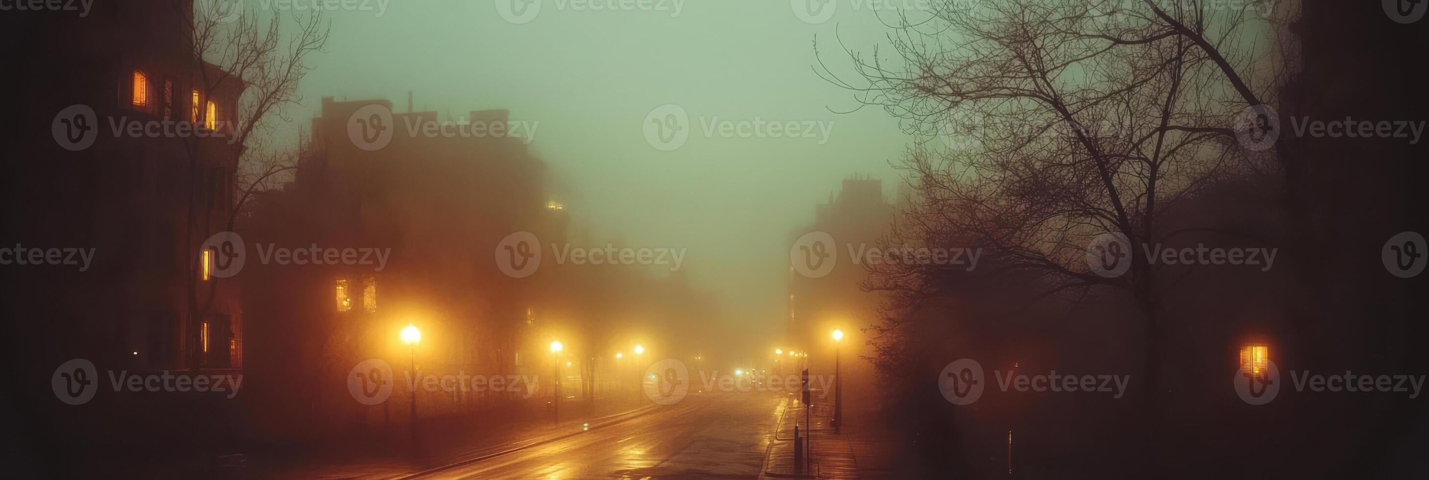Moody urban street at night with lamp posts in dense foggy weather photo