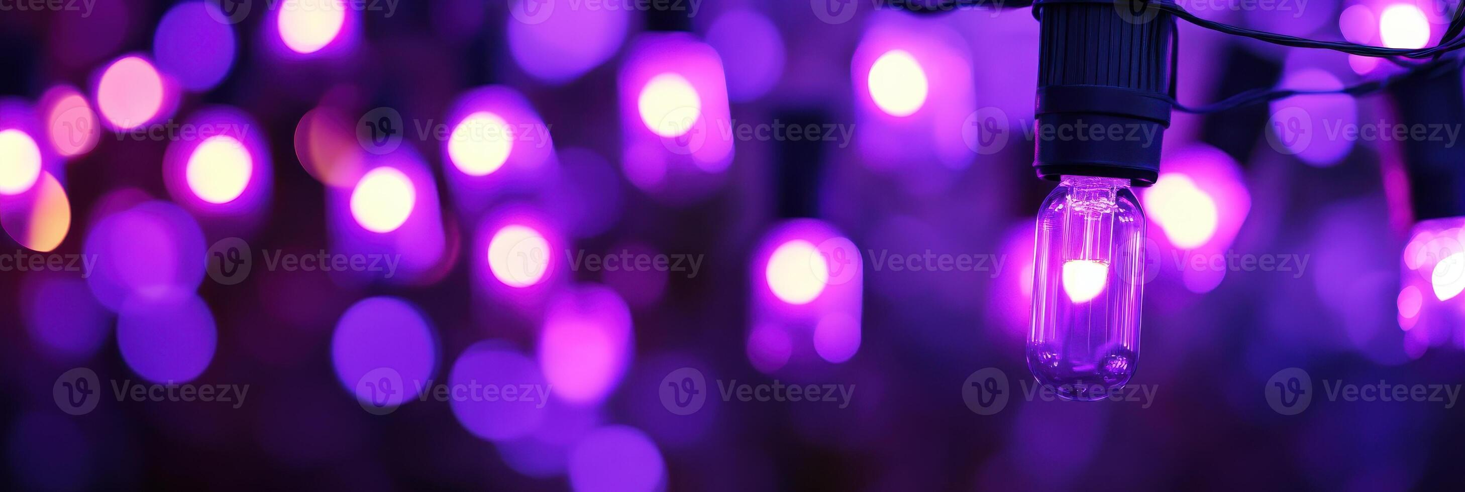 Vibrant purple lights creating a bokeh effect with illuminated bulb focus photo