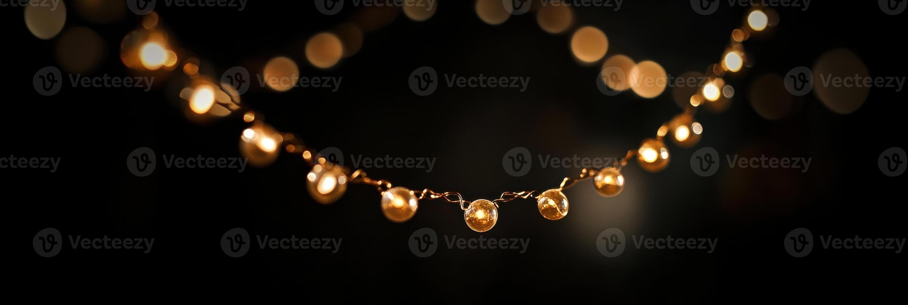 Festive string lights in focus against a dark blurred background for celebrations photo