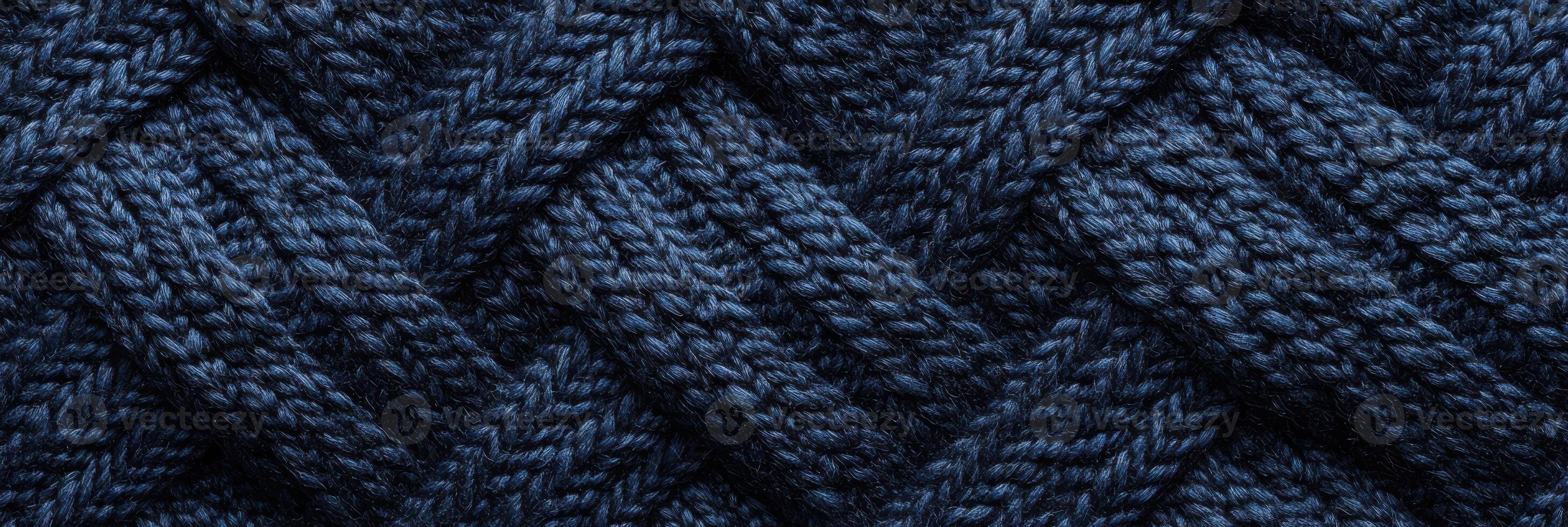 Blue knitted wool texture with interwoven pattern for background and textile design photo