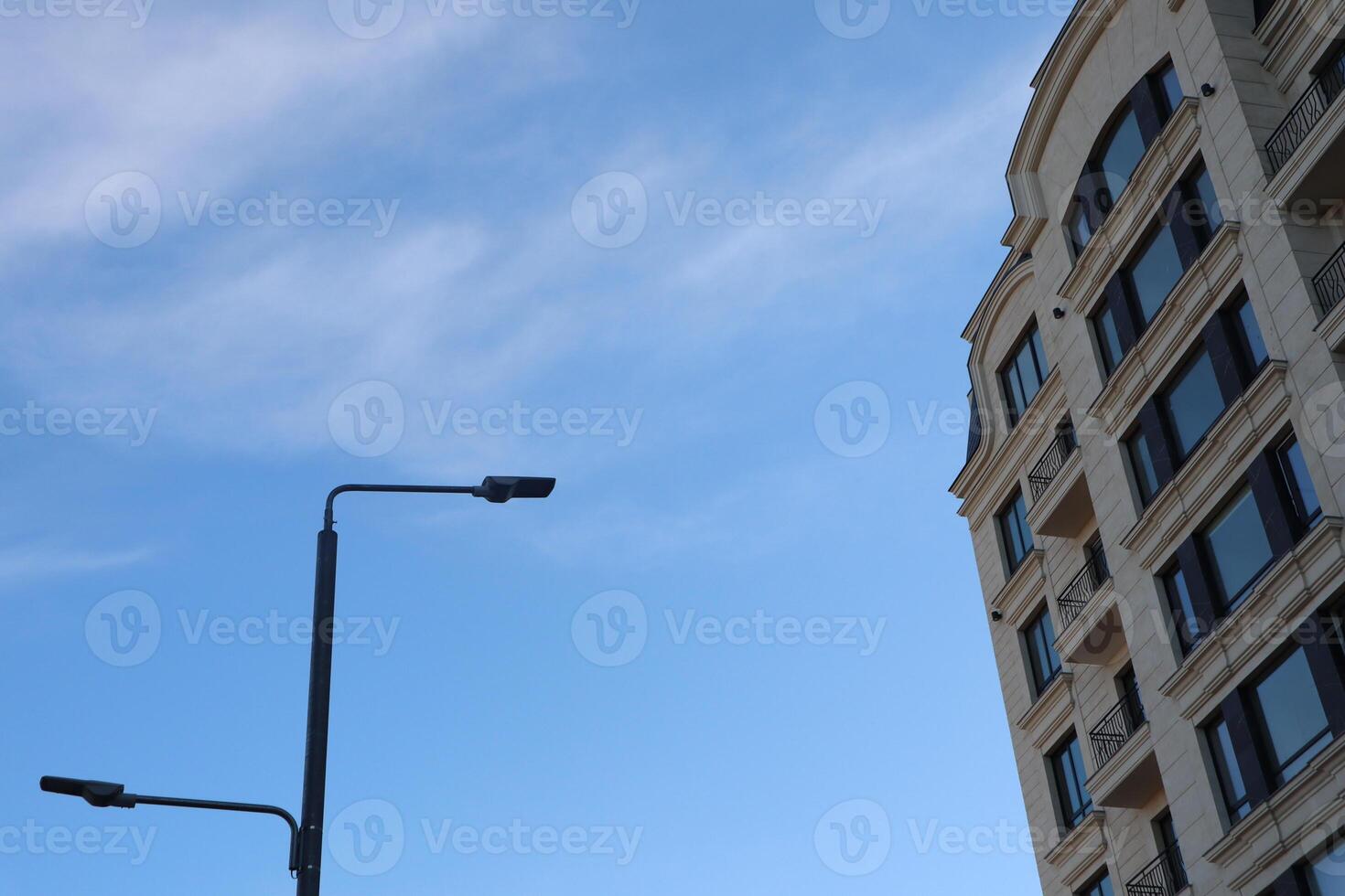 Modern architecture features artistic design set against a bright blue sky, creating allure photo
