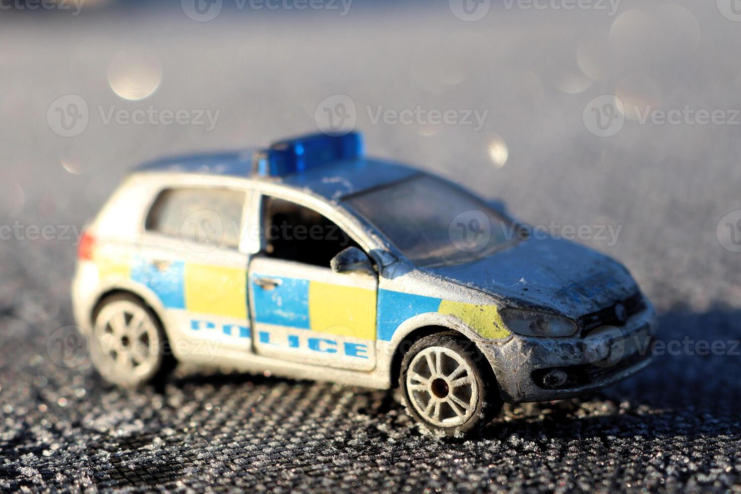 A diecast police car model on display, highlighting its realistic design amid colorful elements photo