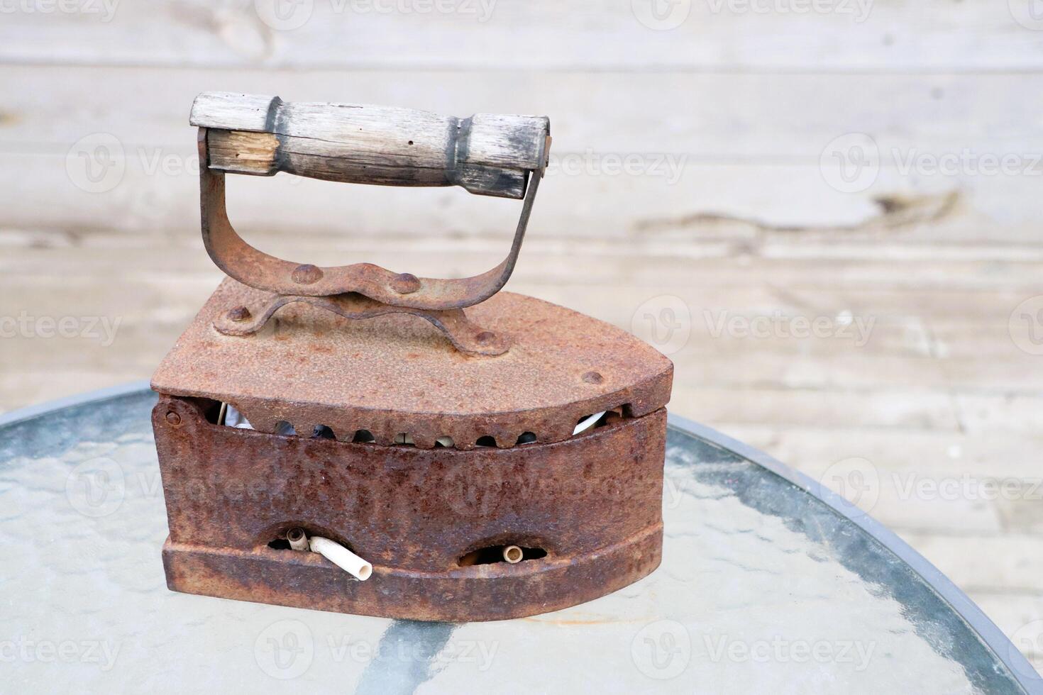 A Beautiful Vintage Rusty Iron on a Glass Table, Perfect for Any Home Decor Style photo