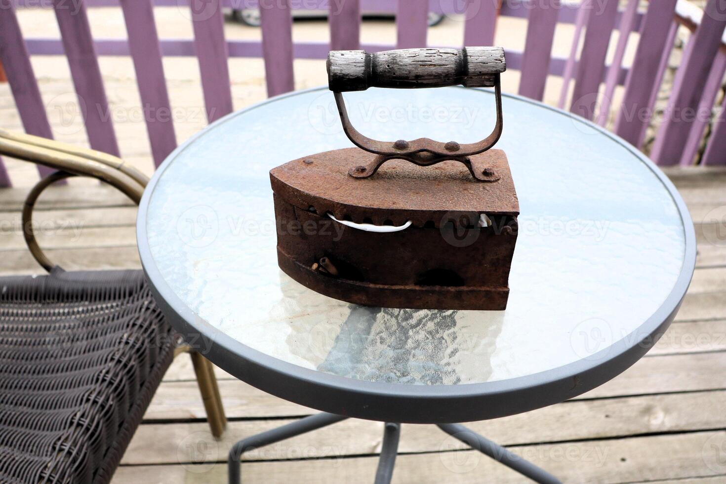 A Beautiful Antique Iron Piece on a Table that Exudes Rustic Charm and Character photo