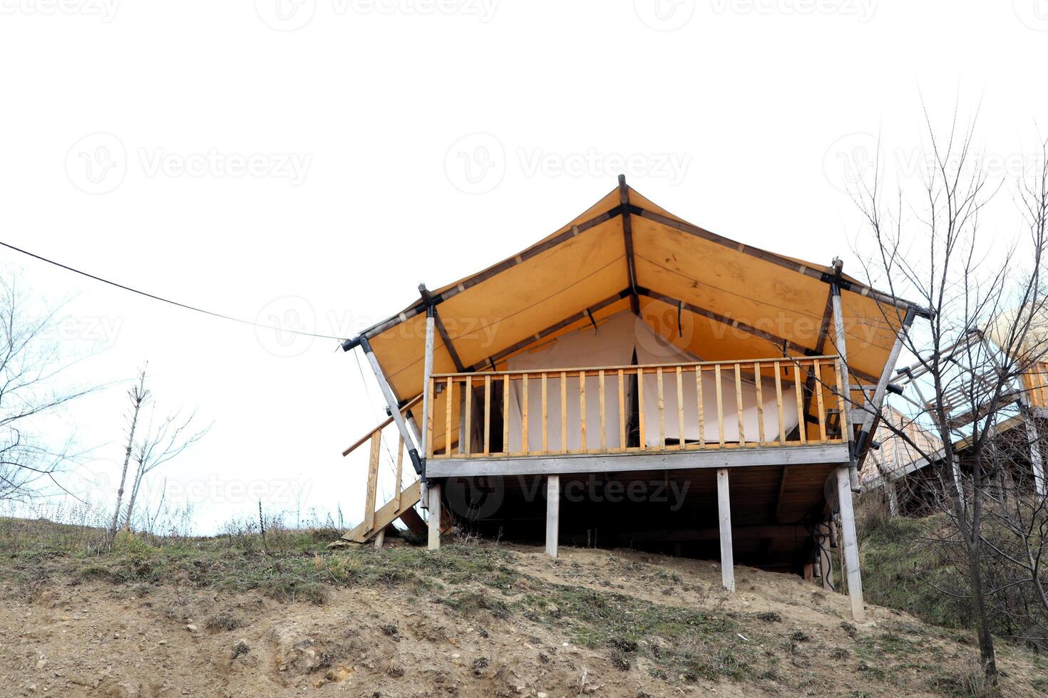 Charming Elevated Glamping Tent Cabin Nestled on a Beautiful Hill Surrounded by Nature photo