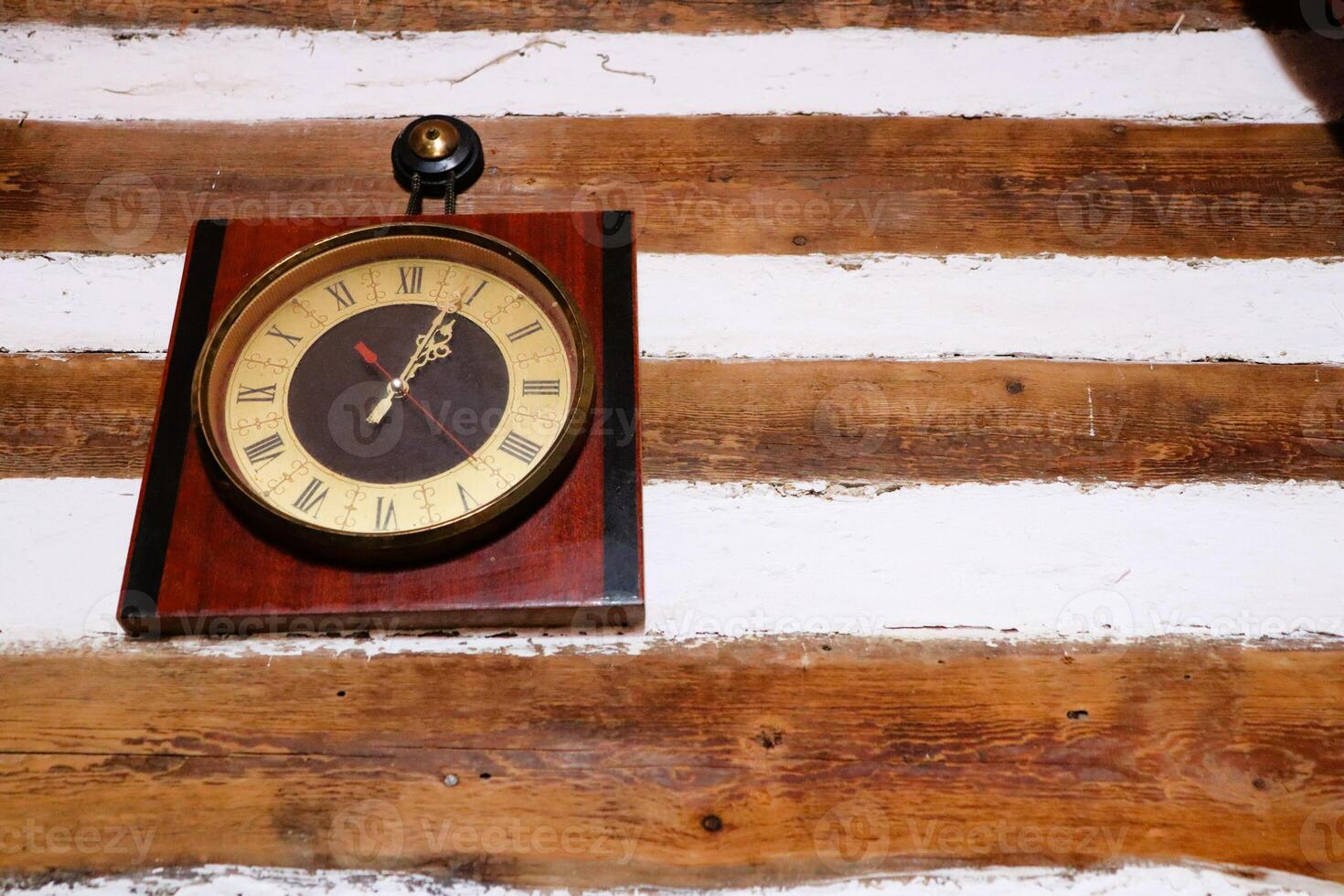 A beautiful Vintage Wall Clock perfectly placed on a Rustic Wooden Background setting photo