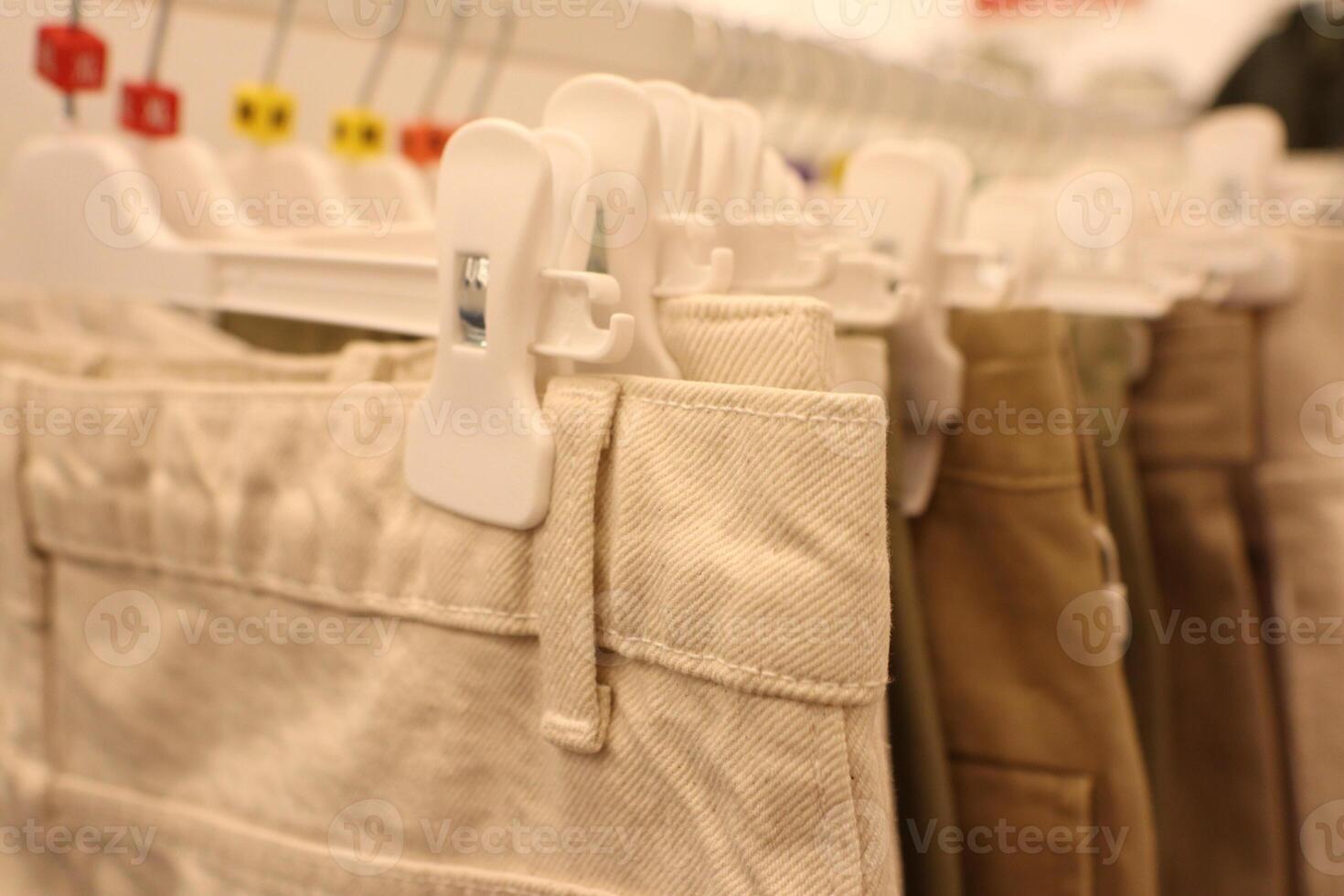 A modern and stylish pants rack display featured in a trendy fashion store setting photo