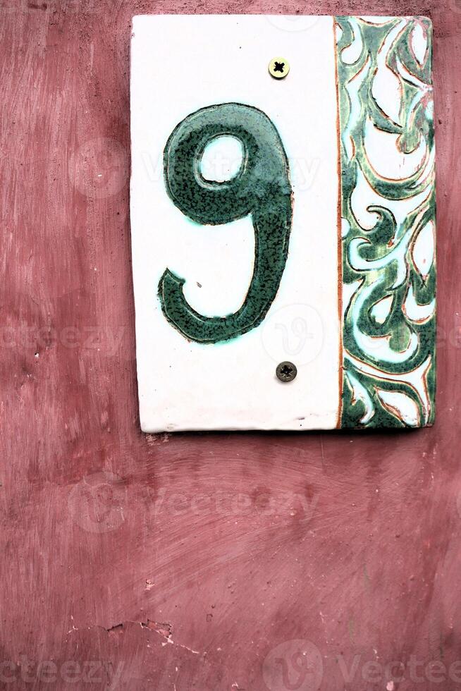 Introducing Stylish House Number 9, featuring a charming decorative background design photo