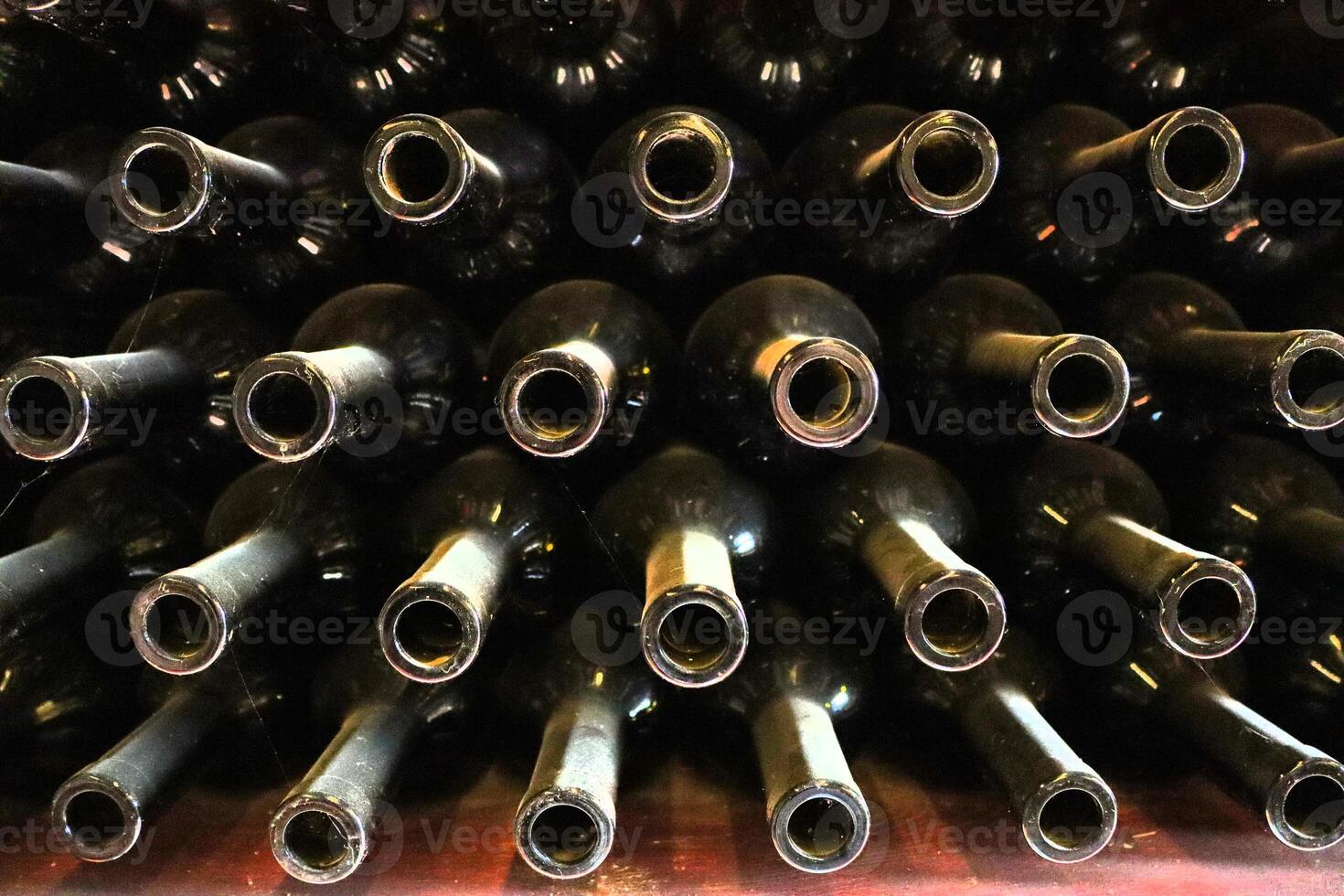 Beautiful and Elegant Wine Bottles Delightfully Stacked in a Charming Vintage Cellar Space photo