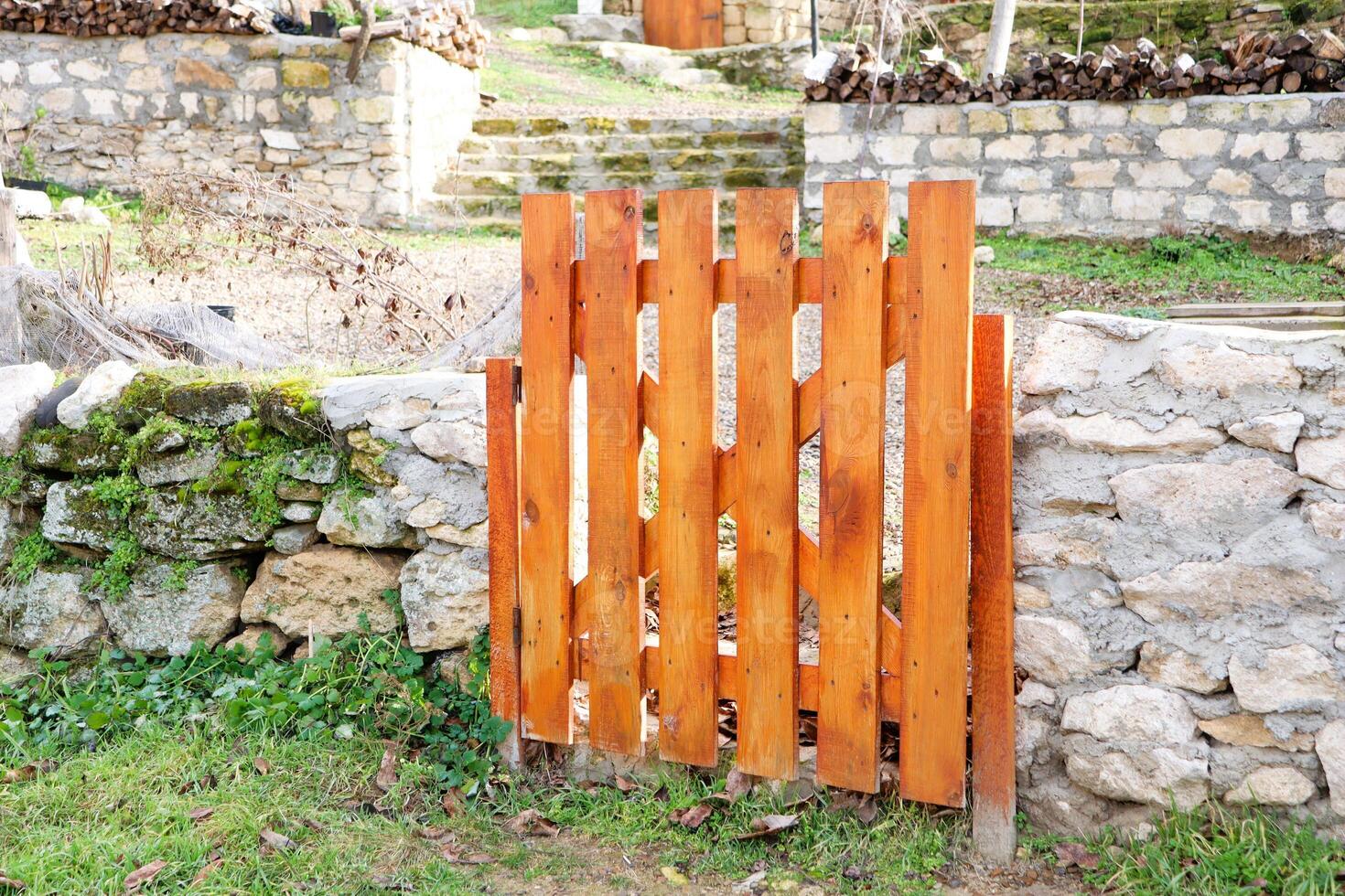 A Beautiful Rustic Wooden Garden Gate Positioned in a Natural and Serene Setting photo